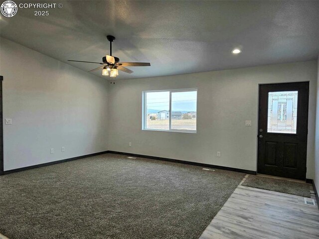 entryway with dark hardwood / wood-style floors and ceiling fan