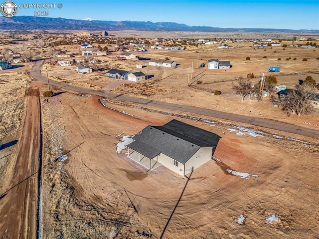 drone / aerial view featuring a mountain view