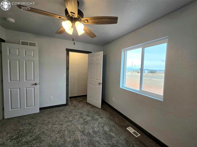 unfurnished bedroom with ceiling fan and carpet flooring