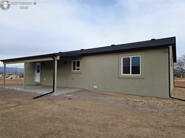 rear view of property featuring a patio