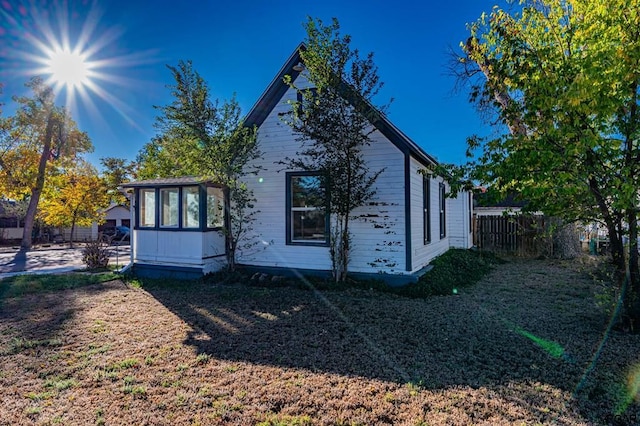 back of property with a sunroom