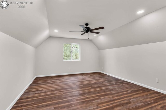 bonus room with baseboards, dark wood finished floors, a ceiling fan, and vaulted ceiling