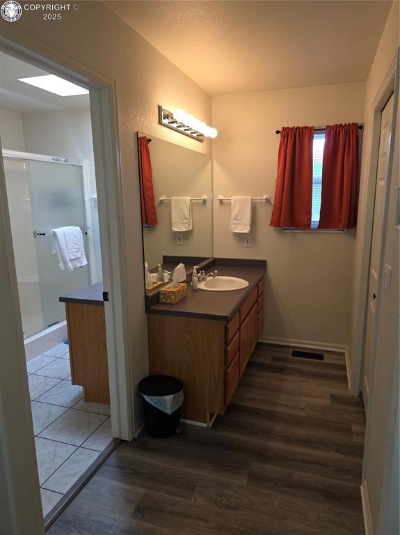 2823 River Run Ct, Canon City, CO 81212 - full bathroom featuring vanity, wood finished floors, and a shower stall