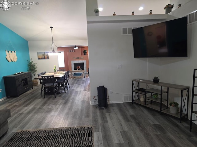 2823 River Run Ct, Canon City, CO 81212 - living area with wood finished floors, a ceiling fan, and a tiled fireplace