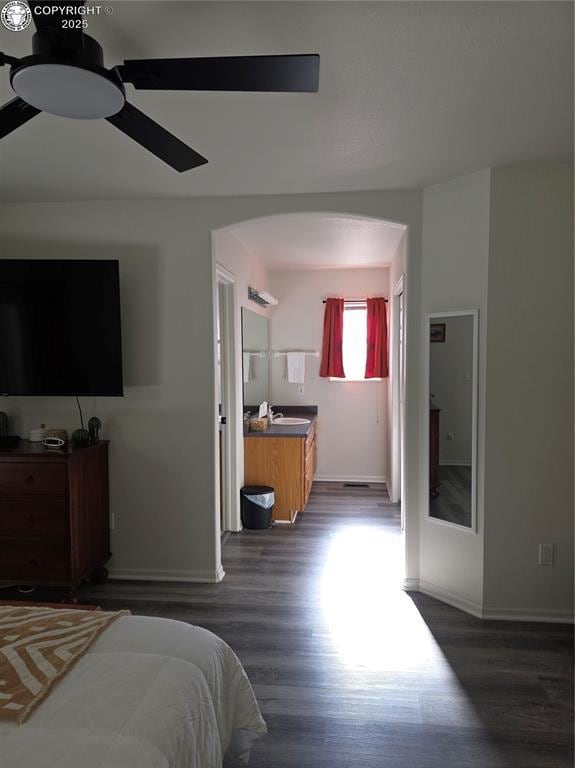 2823 River Run Ct, Canon City, CO 81212 - bedroom featuring dark wood-style flooring, arched walkways, and ceiling fan