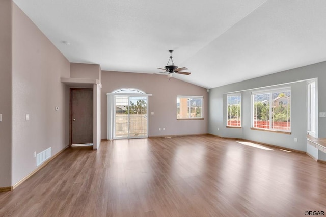 unfurnished living room featuring ceiling fan, lofted ceiling, and light hardwood / wood-style flooring