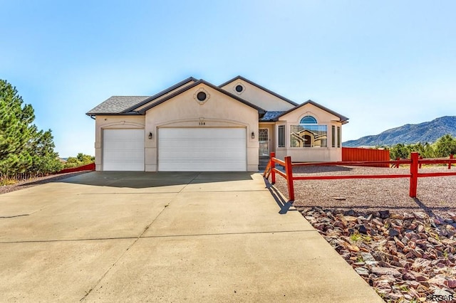 ranch-style home with a garage and a mountain view