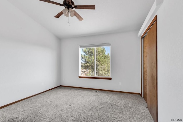 unfurnished bedroom with carpet flooring, ceiling fan, and a closet