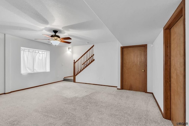 carpeted spare room featuring ceiling fan