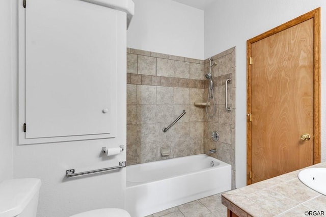 full bathroom with vanity, tile patterned flooring, tiled shower / bath combo, and toilet