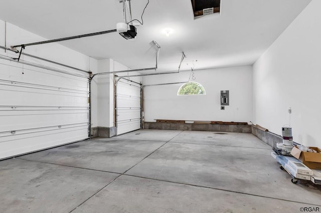 garage featuring a garage door opener and electric panel