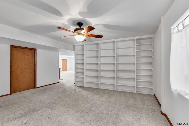 interior space featuring light colored carpet and ceiling fan