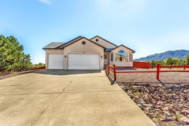 view of front of home with a garage and a mountain view