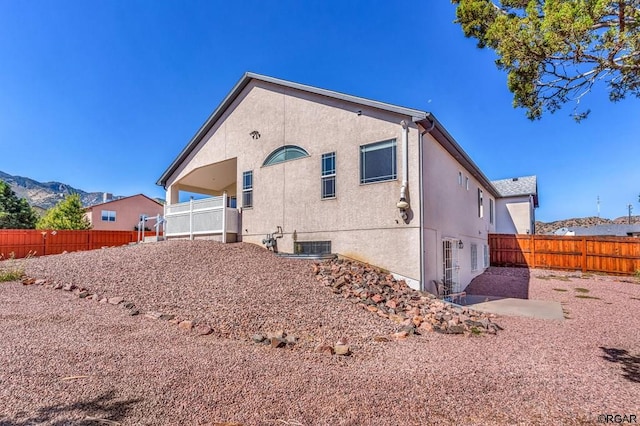 rear view of property with a mountain view and a patio