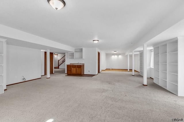 basement with sink and light colored carpet