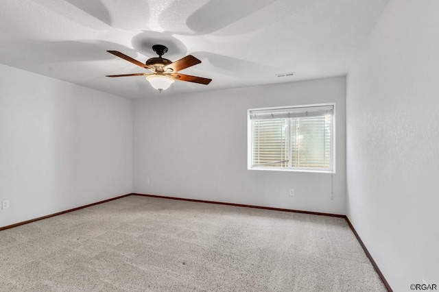 empty room with light colored carpet and ceiling fan