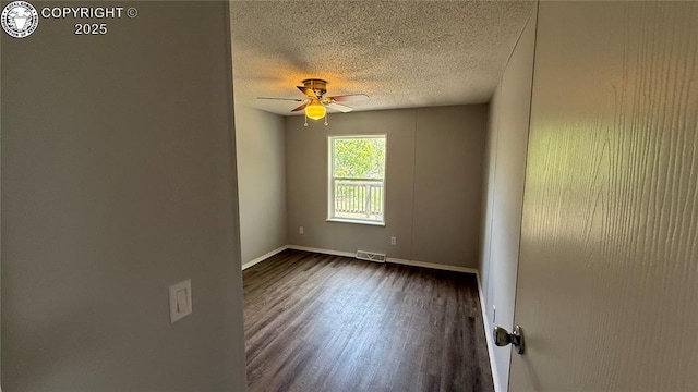 1157 County Road 119, Florence, CO 81226 - unfurnished room featuring a textured ceiling, a ceiling fan, dark wood-style floors, and baseboards