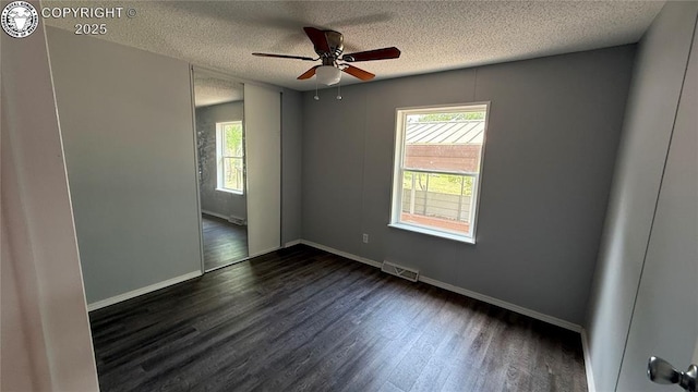 1157 County Road 119, Florence, CO 81226 - spare room with dark wood finished floors, a textured ceiling, baseboards, and a ceiling fan