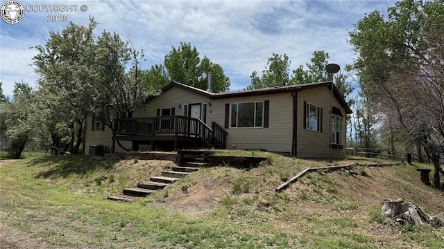 1157 County Road 119, Florence, CO 81226 - view of front of house featuring stairs, a deck, and central AC unit