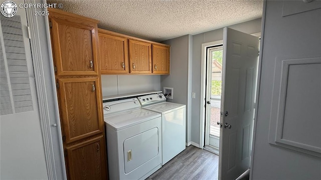 1157 County Road 119, Florence, CO 81226 - washroom with cabinet space, a heating unit, wood finished floors, independent washer and dryer, and a textured ceiling