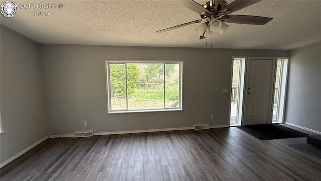 1157 County Road 119, Florence, CO 81226 - entrance foyer with dark wood-type flooring, a textured ceiling, a ceiling fan, and baseboards