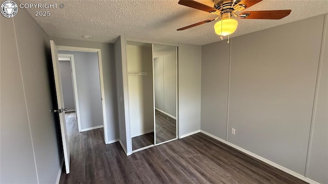 1157 County Road 119, Florence, CO 81226 - unfurnished bedroom with dark wood-style flooring, a textured ceiling, baseboards, a closet, and ceiling fan