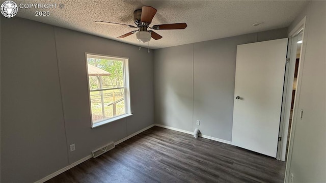 1157 County Road 119, Florence, CO 81226 - unfurnished room with dark wood-style floors, a textured ceiling, ceiling fan, and baseboards