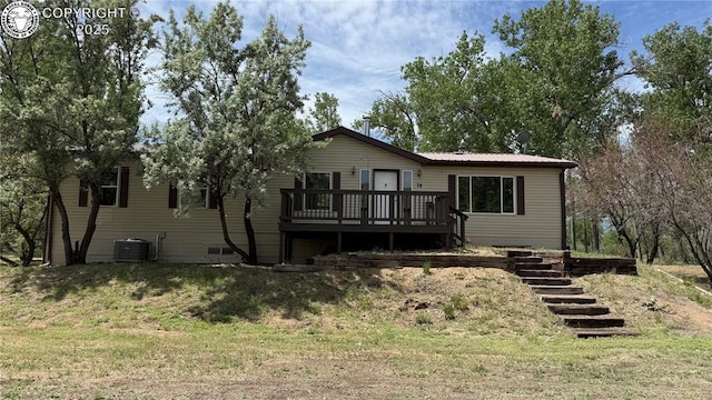1157 County Road 119, Florence, CO 81226 - rear view of property featuring a wooden deck, central AC, stairs, and metal roof
