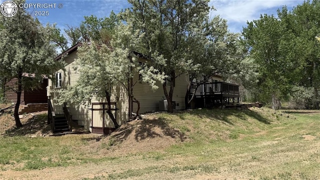 1157 County Road 119, Florence, CO 81226 - view of property exterior with stairs, a lawn, and a wooden deck