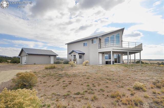 136 Arapahoe Cir, Westcliffe, CO 81252 - rear view of property with a garage, an outbuilding, and a balcony