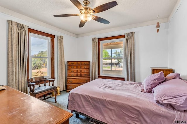 bedroom featuring carpet, a textured ceiling, and ceiling fan