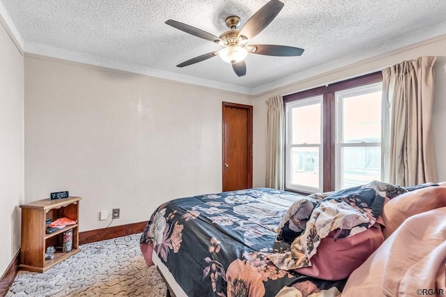 bedroom with ornamental molding, a textured ceiling, and ceiling fan