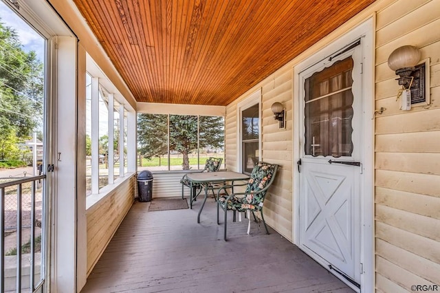 sunroom featuring wood ceiling