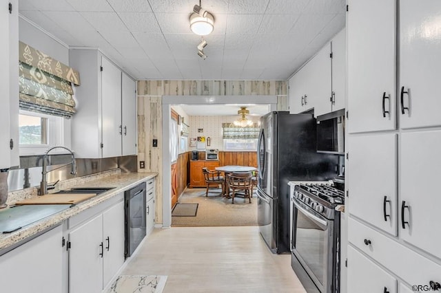 kitchen featuring white cabinetry, appliances with stainless steel finishes, and sink