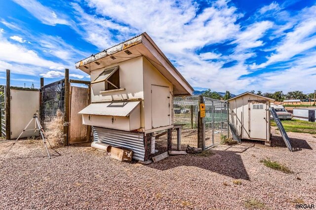 back of house with an outbuilding