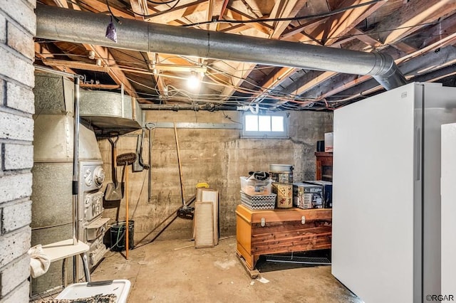 basement with white refrigerator