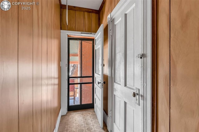 doorway featuring wood walls