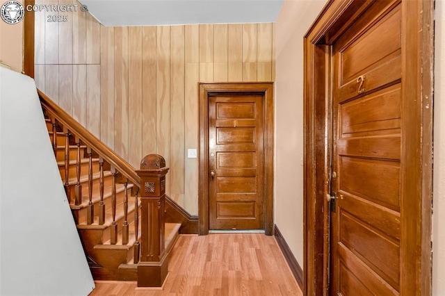 interior space featuring light hardwood / wood-style floors and wood walls