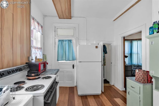 kitchen with white appliances, green cabinets, and light wood-type flooring