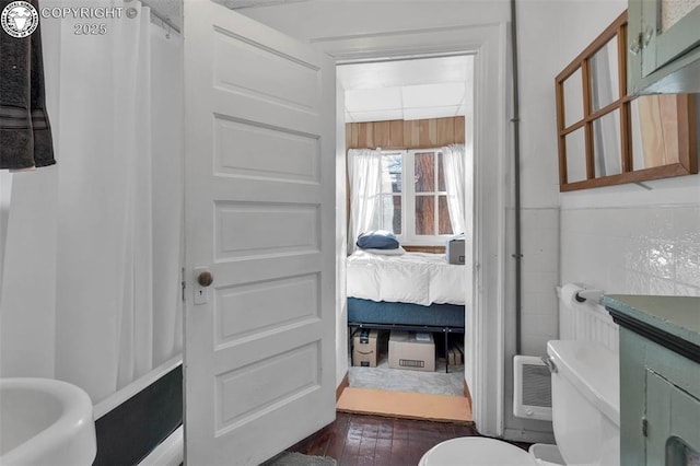 bathroom with hardwood / wood-style flooring and toilet