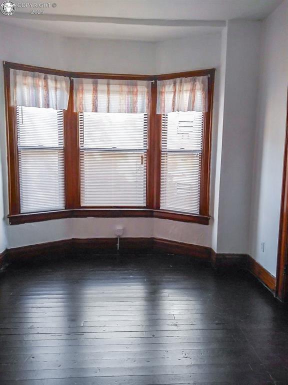 unfurnished room featuring dark hardwood / wood-style flooring