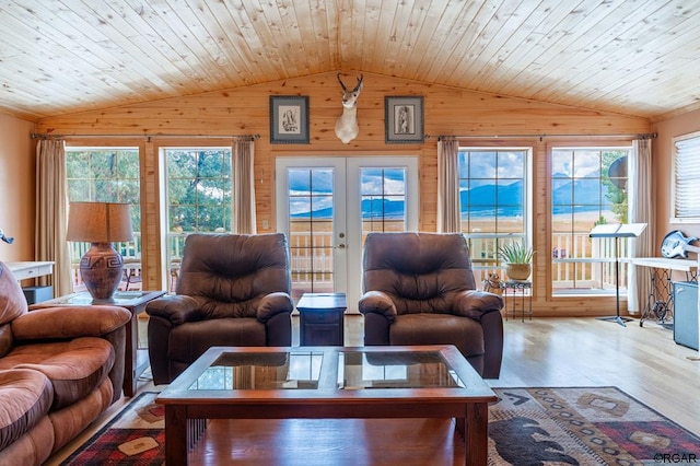 living room with hardwood / wood-style flooring, vaulted ceiling, french doors, and wooden ceiling