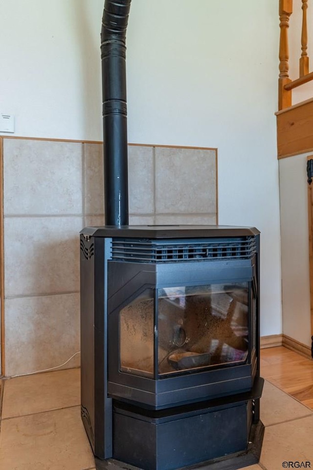 interior details featuring a wood stove and hardwood / wood-style floors