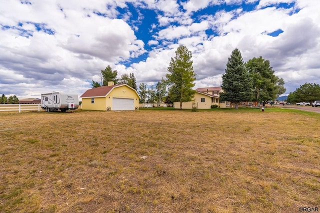 view of yard with an outbuilding and a garage