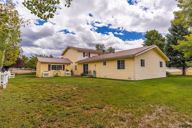 back of property featuring a lawn