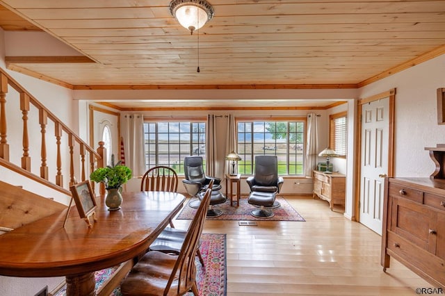 dining room with crown molding, wood ceiling, plenty of natural light, and light hardwood / wood-style floors