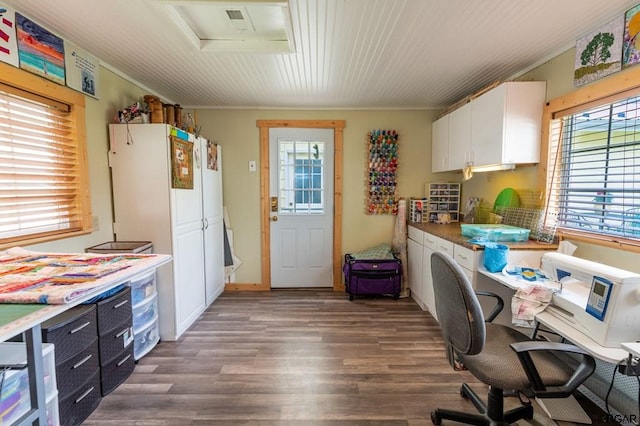 kitchen with white cabinetry, dark wood-type flooring, and ornamental molding