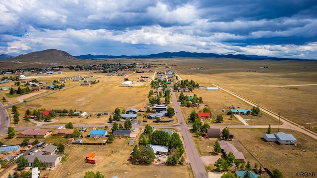 birds eye view of property with a mountain view and a rural view