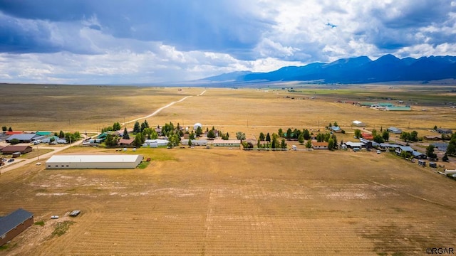 drone / aerial view featuring a mountain view and a rural view