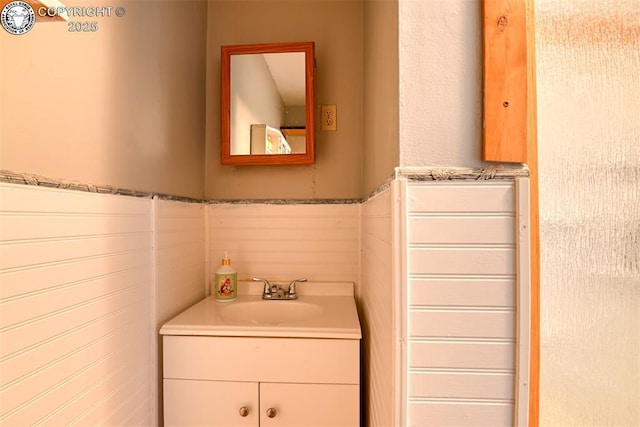1110 Euclid Ave, Pueblo, CO 81004 - bathroom with vanity, tile walls, and a wainscoted wall